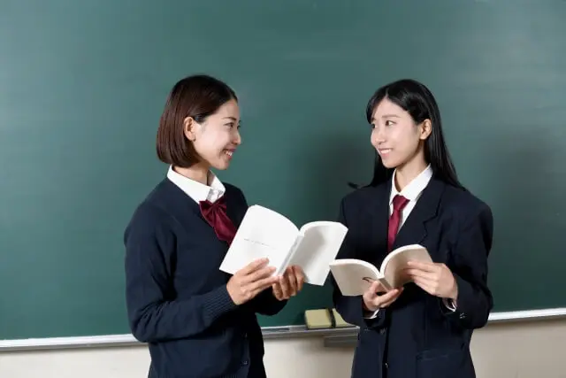 教科書を手に、会話している女子生徒